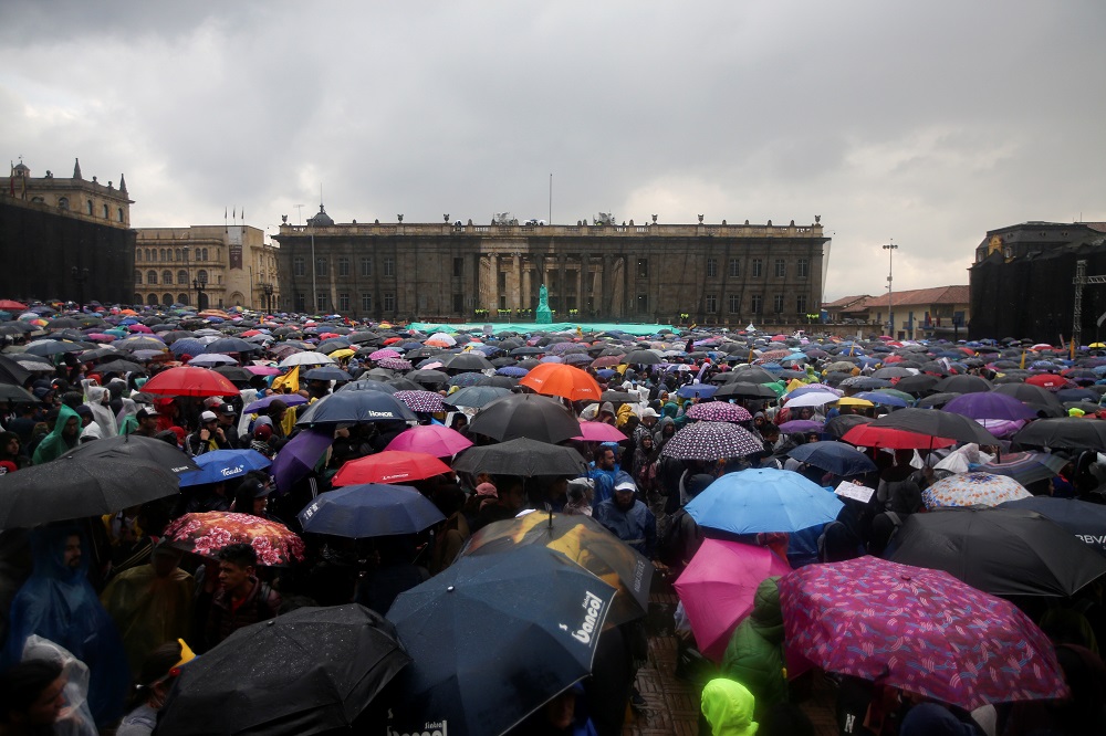 Demonstrators hold umbrellas as they take part in a protest in Bogota Colombia November 21 2019 REUTERS Luisa Gonzalez