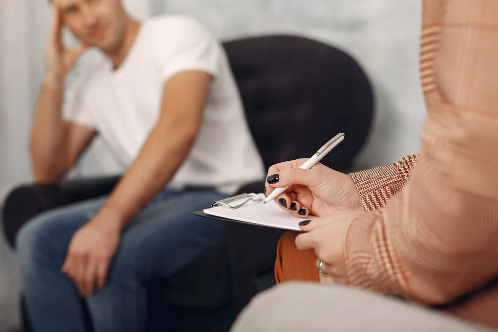 man-sitting-psychologist-s-office-talking-about-problems